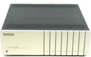 A white and black amplifier is sitting on the floor