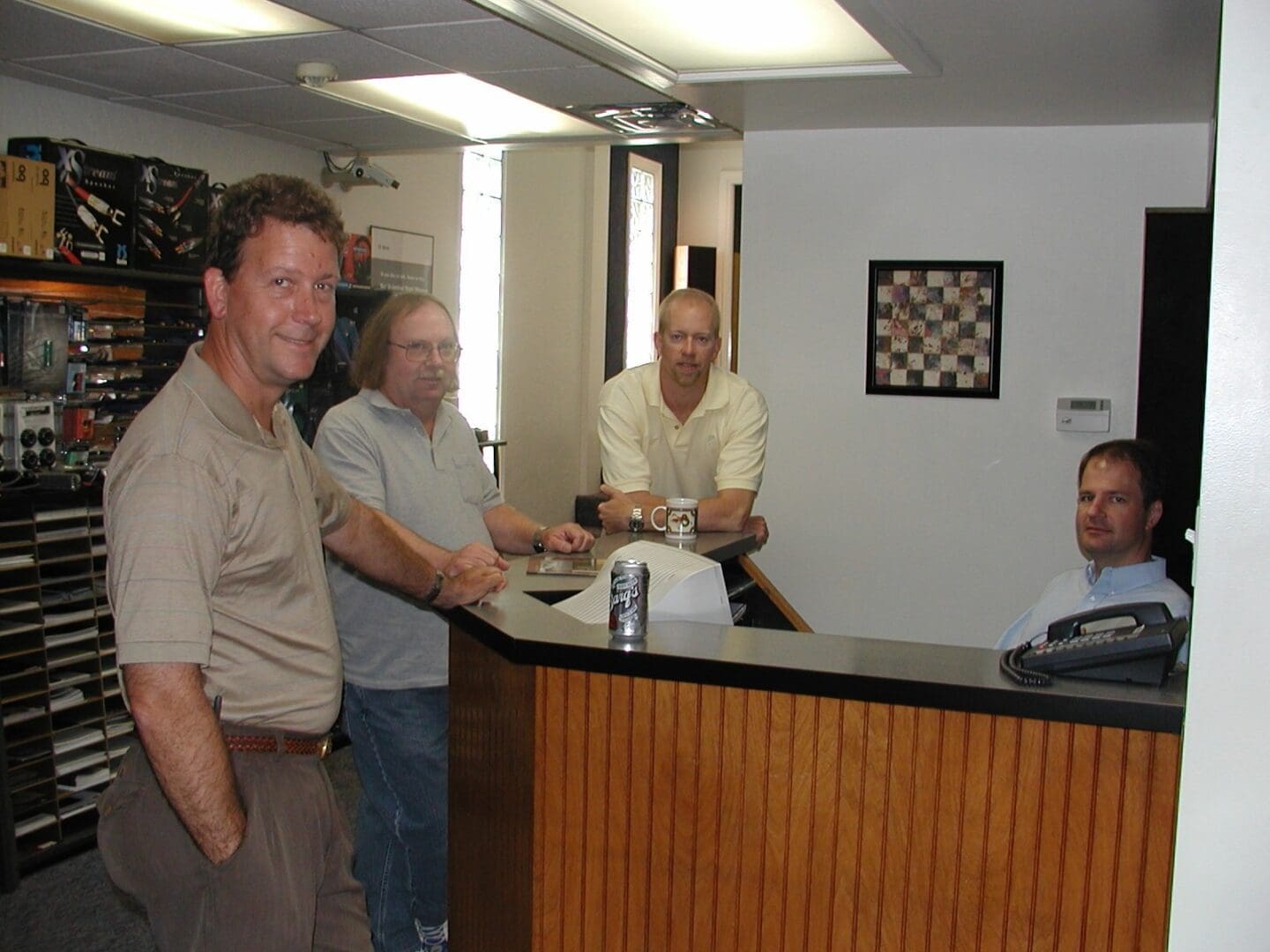 A Hi-Fi group of men at The Sound Station in Bartlesville standing around a counter.