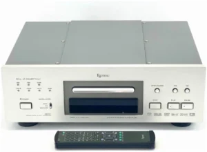 A remote control is next to the cd player.